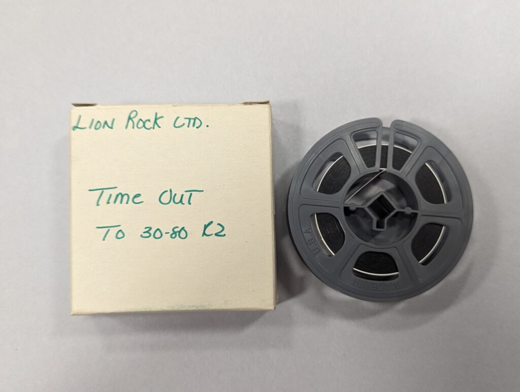 A film reel and a box labeled "Lion Rock Ltd., Time Out, TO 30-80 R2."