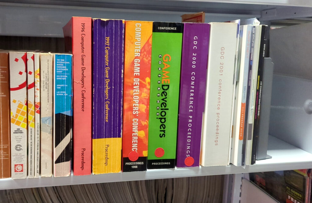 A collection of GDC proceedings books on a shelf.