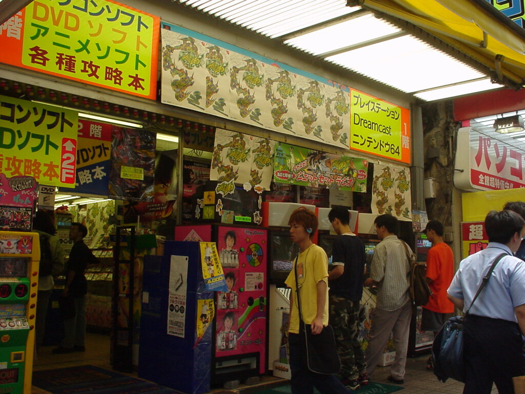 Exterior of a game store in Akihabara. Posters and stickers for Jet Set Radio dot the exterior windows.
